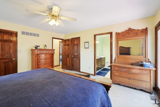 bedroom featuring carpet, connected bathroom, visible vents, and a ceiling fan