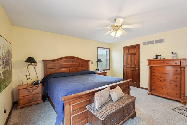 bedroom with baseboards, a ceiling fan, visible vents, and light colored carpet