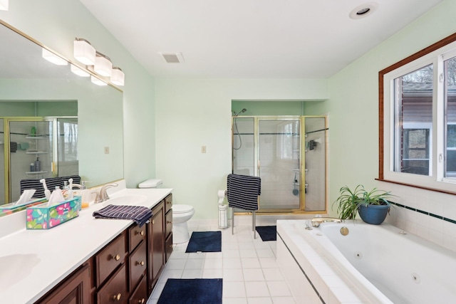 bathroom with double vanity, toilet, a stall shower, a sink, and a tub with jets