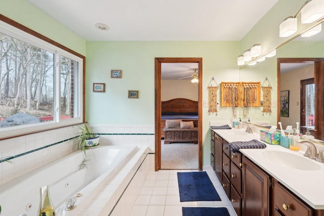 ensuite bathroom featuring connected bathroom, a sink, a jetted tub, tile patterned floors, and double vanity