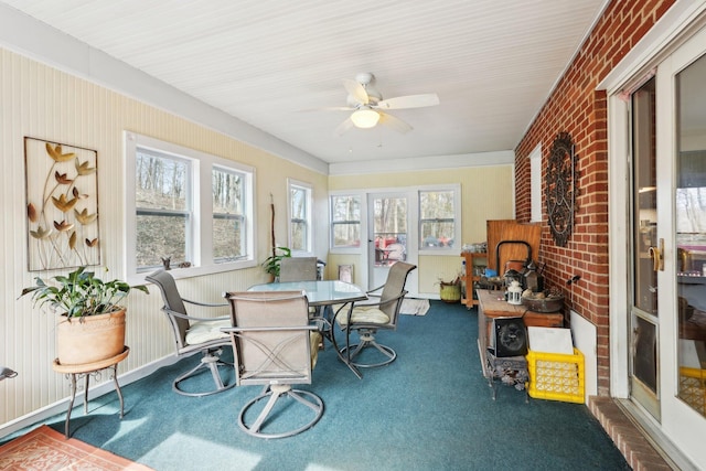 sunroom / solarium with a wealth of natural light and a ceiling fan