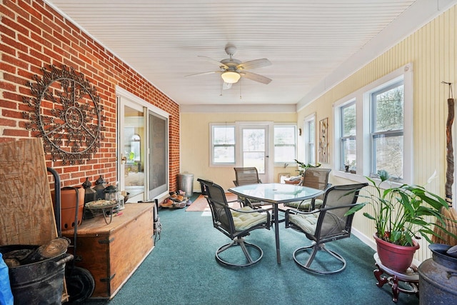 sunroom / solarium with a ceiling fan