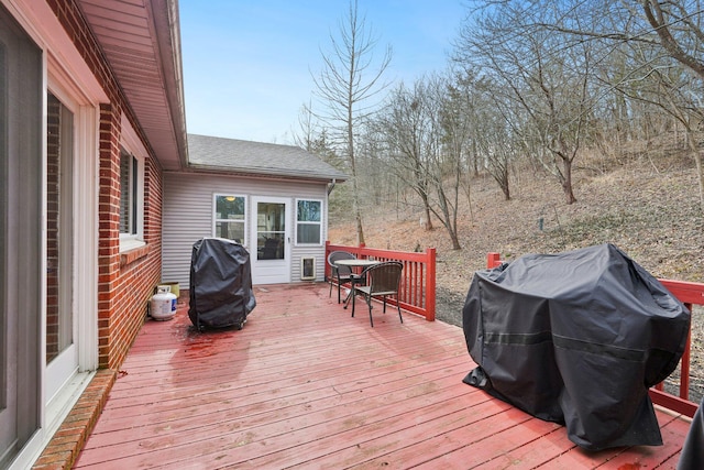 wooden terrace with a grill