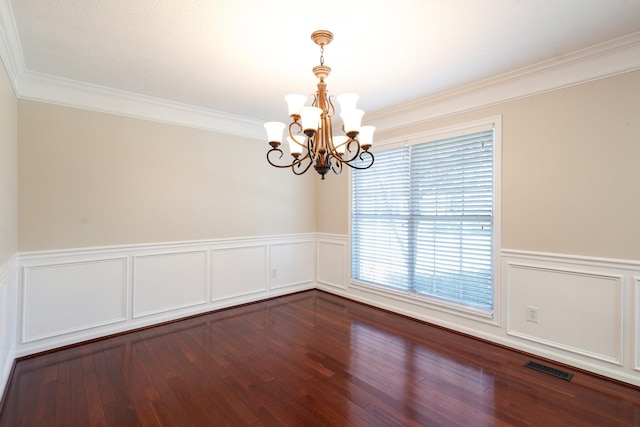 unfurnished room with visible vents, a wainscoted wall, an inviting chandelier, and dark wood-style floors