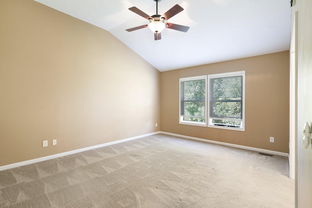 unfurnished room featuring light colored carpet, baseboards, lofted ceiling, and a ceiling fan