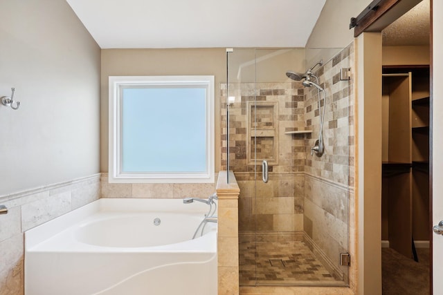 bathroom featuring a shower stall and a garden tub