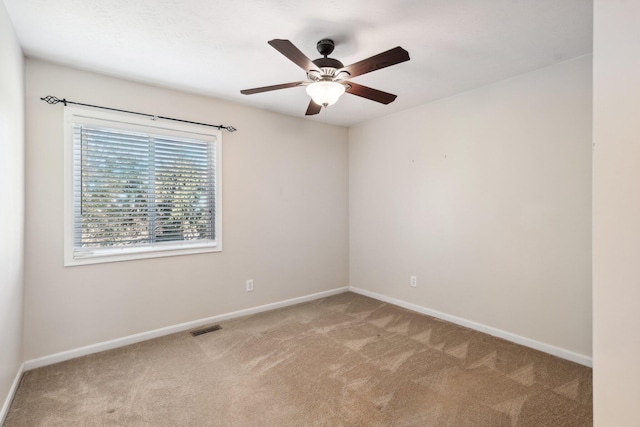 unfurnished room featuring a ceiling fan, carpet, visible vents, and baseboards