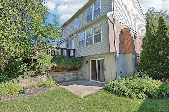 back of property with a patio area and a yard