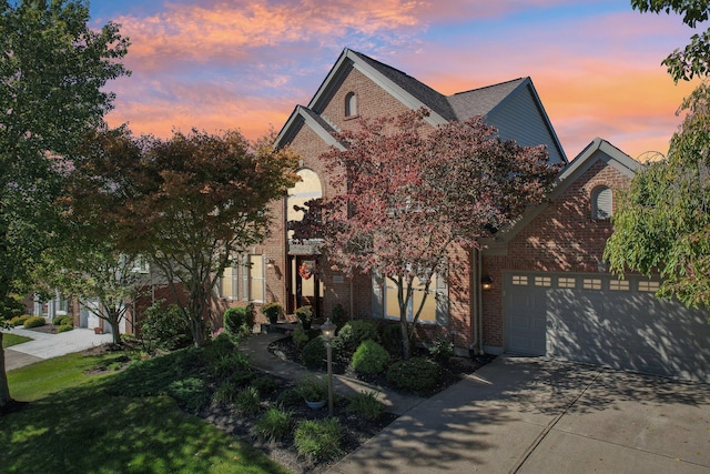 view of front of house featuring a garage, brick siding, and concrete driveway