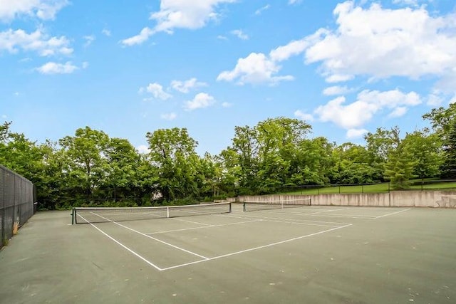 view of sport court featuring fence