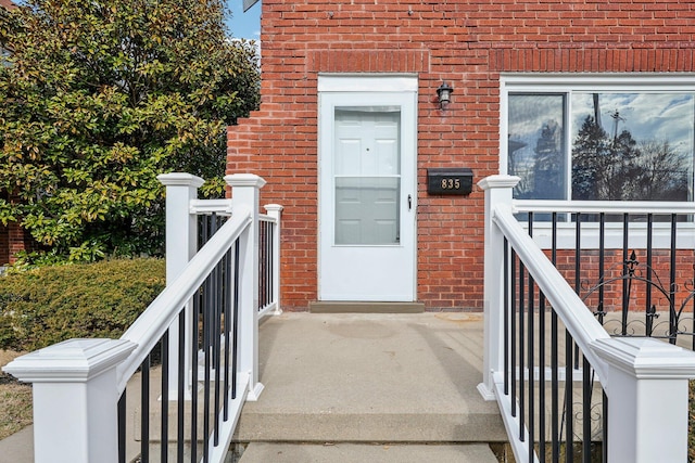 property entrance featuring brick siding