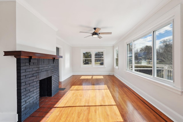 interior space featuring plenty of natural light, a fireplace, and a ceiling fan