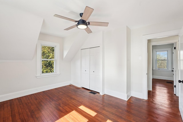 bonus room featuring ceiling fan, hardwood / wood-style flooring, visible vents, and baseboards