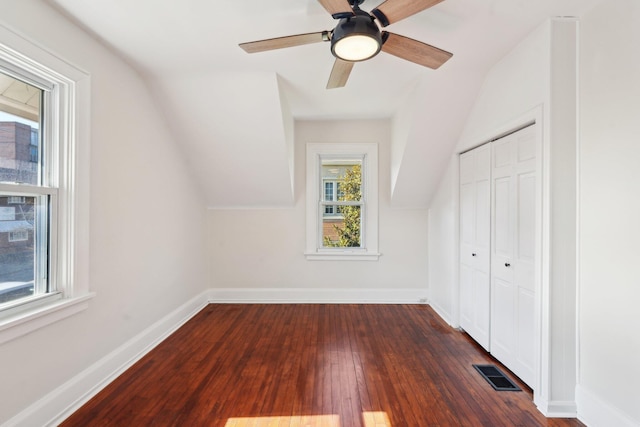 bonus room with vaulted ceiling, visible vents, dark wood finished floors, and baseboards