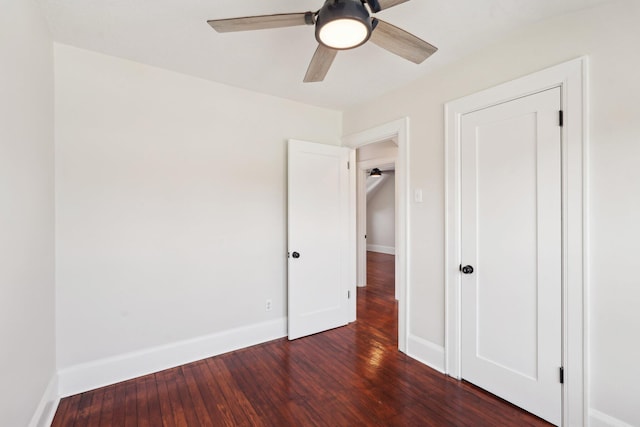 unfurnished bedroom featuring dark wood-style floors and baseboards