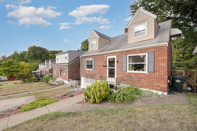 cape cod-style house featuring brick siding