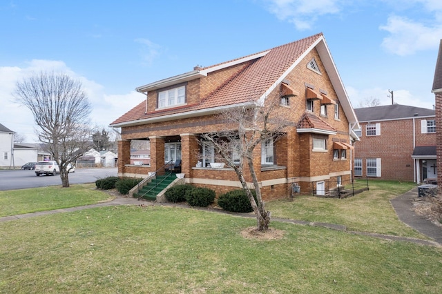 bungalow-style house with a porch, a front lawn, and brick siding