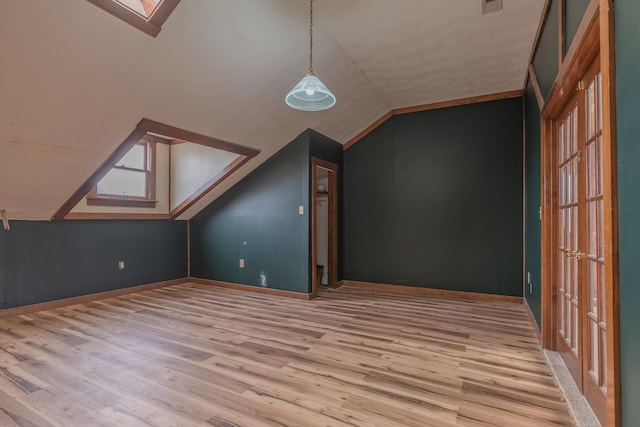 9208 Hawksridge Dr, Covington, KY 41017 - additional living space with vaulted ceiling with skylight, baseboards, and wood finished floors