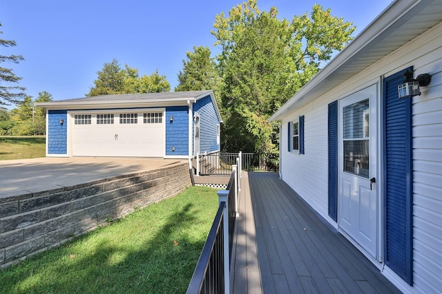 deck with a detached garage, an outbuilding, and a yard