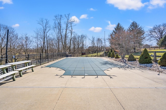 view of pool featuring a patio area, fence, and a fenced in pool