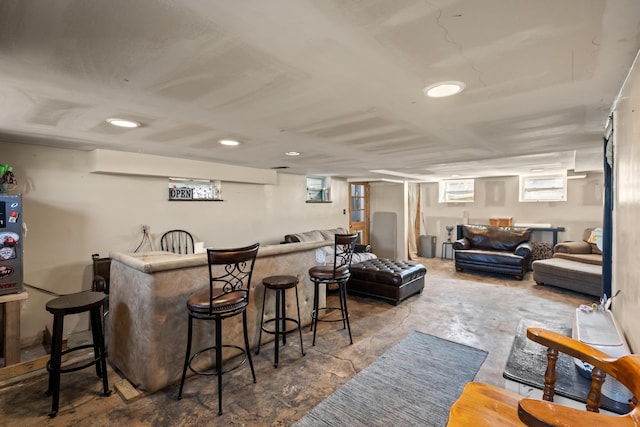 bar with a dry bar and concrete floors