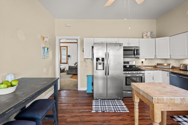 kitchen featuring white cabinets, dark wood-style floors, dark countertops, and stainless steel appliances