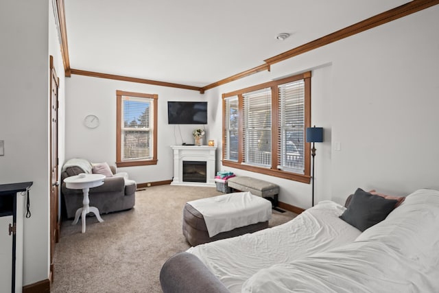 carpeted bedroom with a glass covered fireplace, crown molding, and baseboards