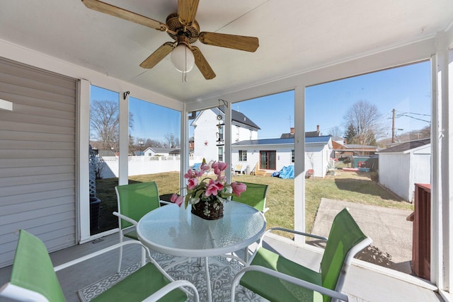 sunroom featuring ceiling fan