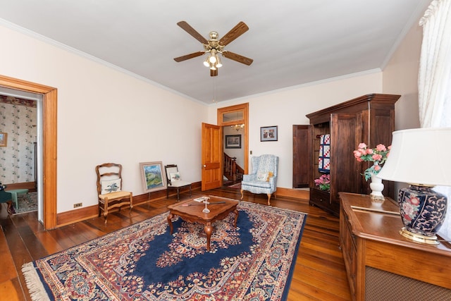 living room featuring ornamental molding, wood-type flooring, ceiling fan, and baseboards