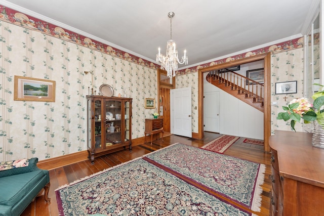 entrance foyer featuring crown molding, hardwood / wood-style floors, stairway, and wallpapered walls