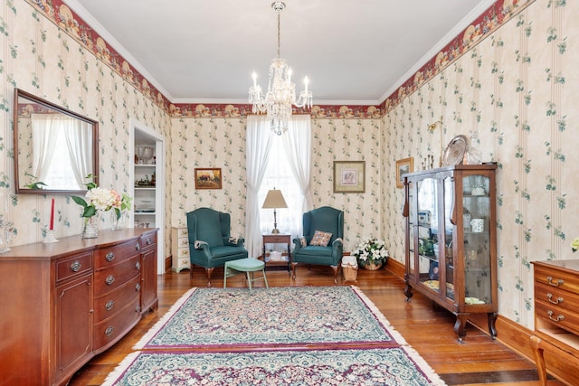 sitting room featuring light wood-style floors, ornamental molding, and wallpapered walls