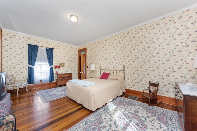 bedroom featuring visible vents, hardwood / wood-style floors, ornamental molding, baseboards, and wallpapered walls