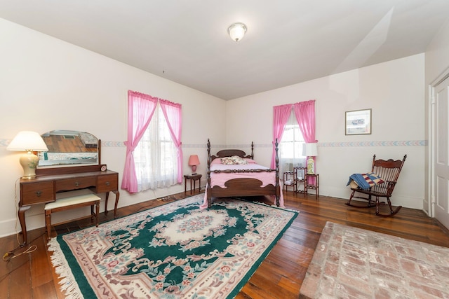 bedroom featuring baseboards and hardwood / wood-style flooring