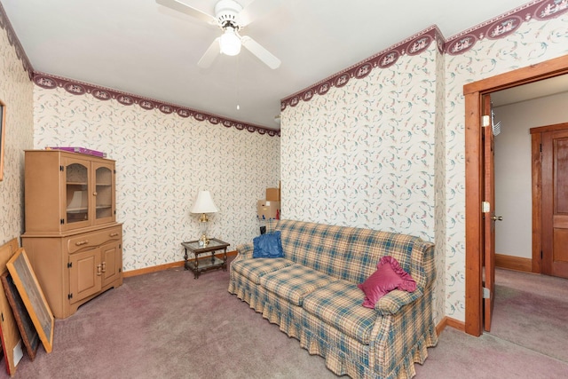 living area featuring light carpet, wallpapered walls, ceiling fan, and baseboards