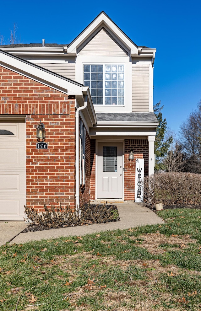 view of front of property featuring brick siding and an attached garage