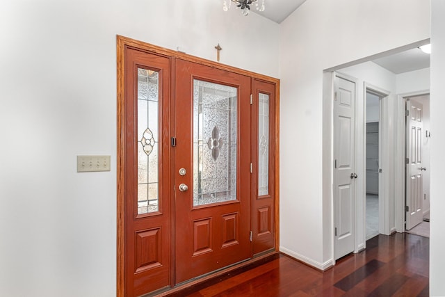 foyer with dark wood-style floors, baseboards, and a healthy amount of sunlight