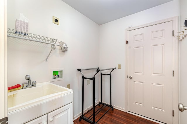 laundry room featuring a sink, dark wood-style floors, baseboards, hookup for an electric dryer, and hookup for a washing machine