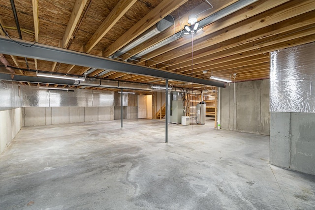 unfinished below grade area featuring gas water heater and heating unit