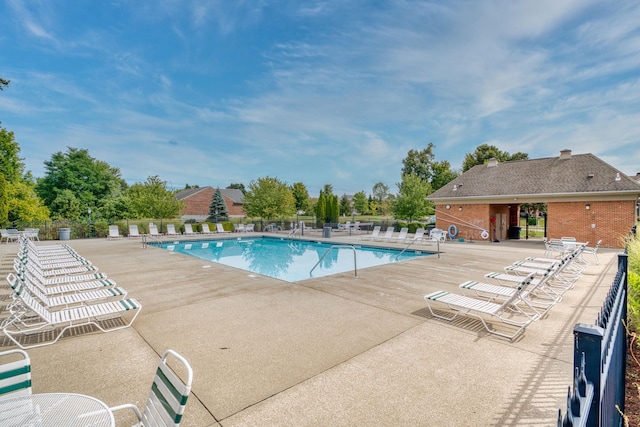 community pool featuring a patio area and fence