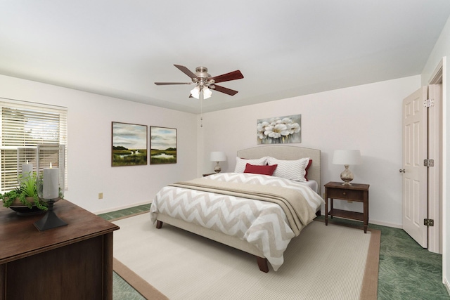 carpeted bedroom with baseboards and ceiling fan