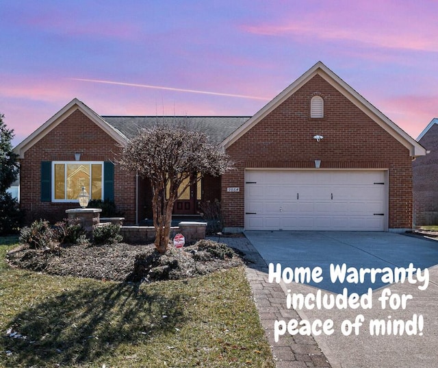 ranch-style house with brick siding, concrete driveway, and a garage