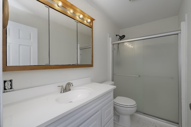 full bathroom with toilet, marble finish floor, a stall shower, and vanity