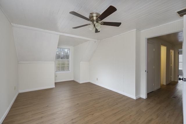 bonus room featuring vaulted ceiling, wood finished floors, visible vents, and a ceiling fan