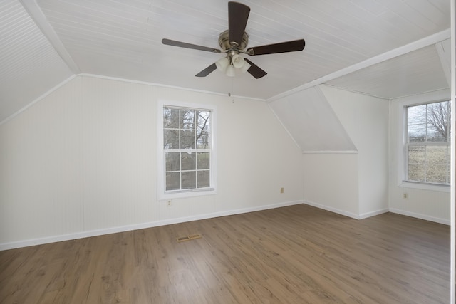 bonus room with visible vents, baseboards, lofted ceiling, ceiling fan, and wood finished floors