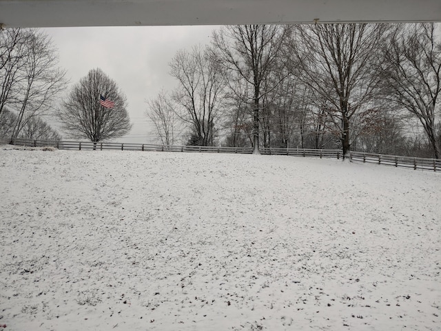 yard covered in snow with fence