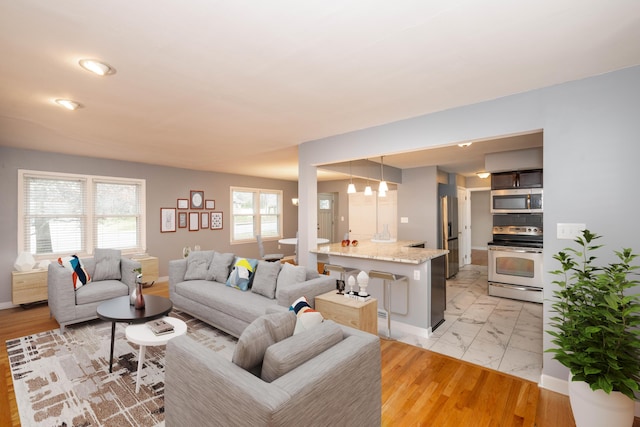 living room featuring marble finish floor and baseboards