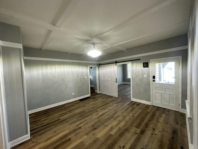 entryway featuring dark wood-style floors, beam ceiling, a barn door, coffered ceiling, and baseboards