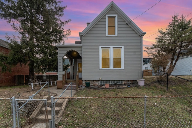 view of front of house featuring a front lawn, a fenced front yard, and a gate