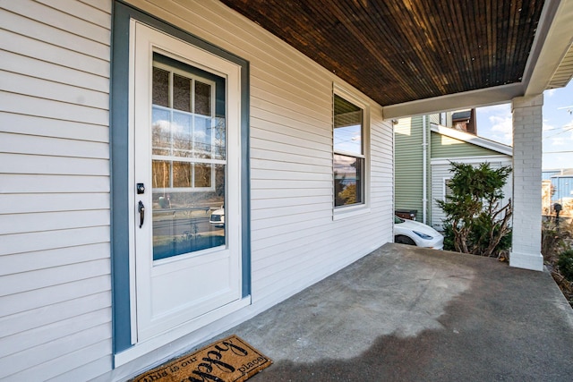 view of exterior entry with a porch