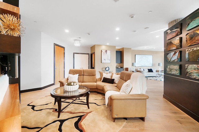 living room featuring light wood-type flooring, recessed lighting, and baseboards